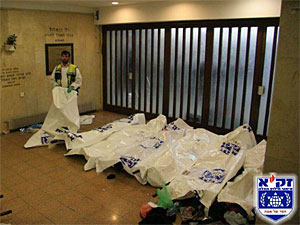 Zaka volunteers covering the bodies of murdered Israelis (Photo: Zaka)