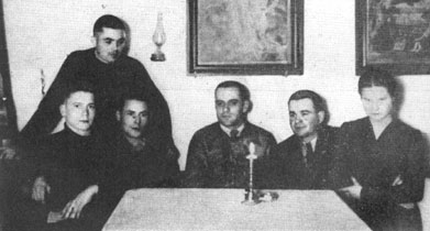 Photo taken an hour after Komski's arrival in Andrzej Harat's house after his escape from Auschwitz. From left: Mieczyslaw Januszewski, Jan Komski(standing), Otto Kusel, Boleslaw Kuczbara, Andrzej Harat and his daughter Wladyslawa Harat.