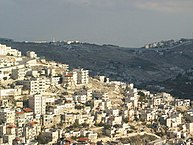 East Jerusalem, with Israeli West Bank barrier in the background (By Anthony Baratier - Own work, CC BY-SA 3.0)