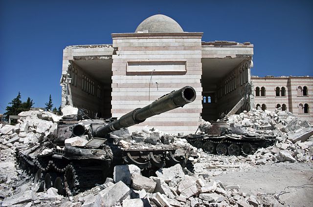 Two destroyed Syrian tanks, in front of a mosque in Azaz