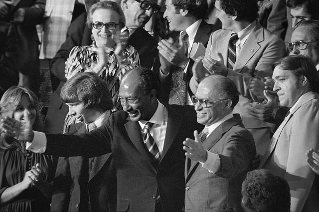 Egyptian President Anwar Sadat and Israeli Prime Minister Menachem Begin acknowledge applause during the announcement of the results of the Camp David Accords.