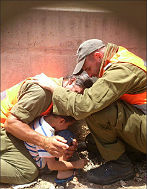 IDF officers shield child, protecting him with their own bodies during a Hamas rocket attack (photo credit: Li Aviv Dadon - IDF photo)